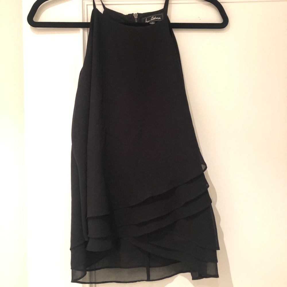 Black tank top with ruffles at bottom